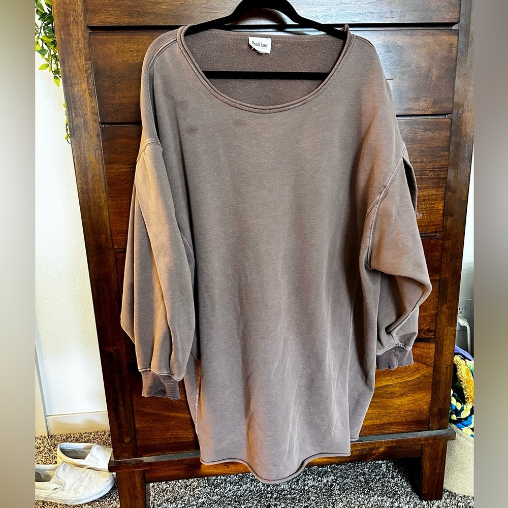 This is a good brown sweater dress. There are 3 removable stains on the front.